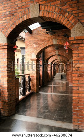 old corridor with red brick and dark blue marble ground.