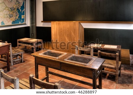 Empty old classroom with wooden chair and desk.