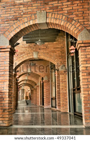 Antique corridor with red brick and dark blue marble ground.