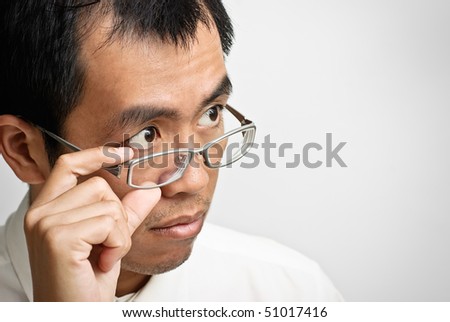 Asian businessman watch and put hand on glass.