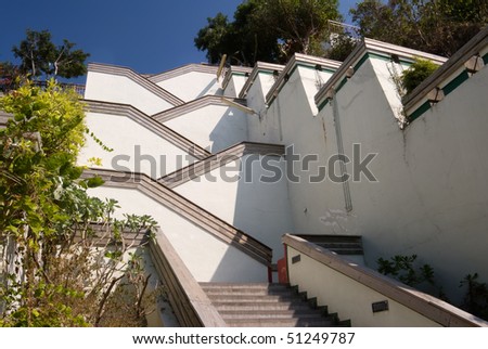 Street with stairs in outdoor with white color under blue sky. Famous landmark in Kaohsiung, Taiwan.