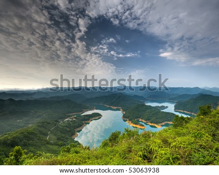 Dramatic landscape of lake with clouds reflection on water in day.