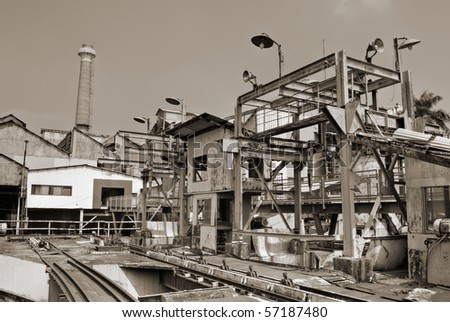 Architecture of industrial factory exterior with buildings and smokestack.