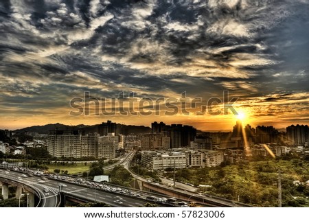 City scenery of sunset with cars busy on road under dramatic sky in Taipei, Taiwan.