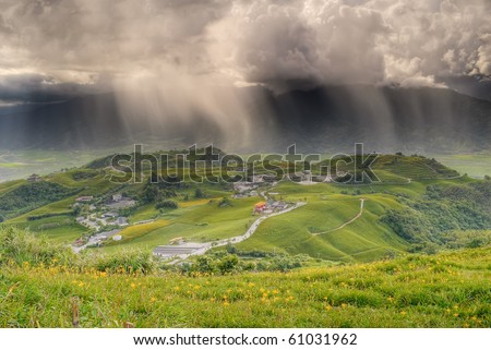 Bad weather landscape of countryside with rain on hills in farm.