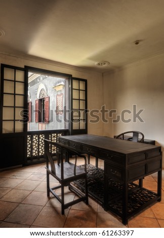 Architecture of Chinese room, interior with wooden chair and desk and windows.