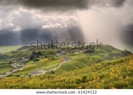 Dramatic landscape of countryside with hills under bad weather cloudy sky.