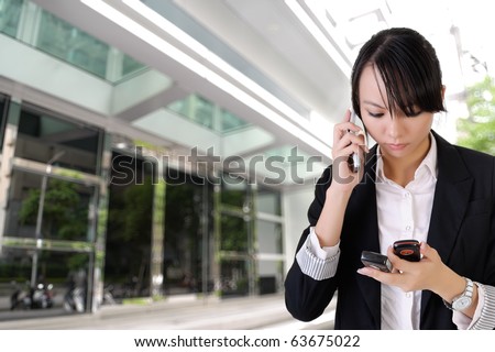 Anxious business woman phone someone and reading SMS outside of office.