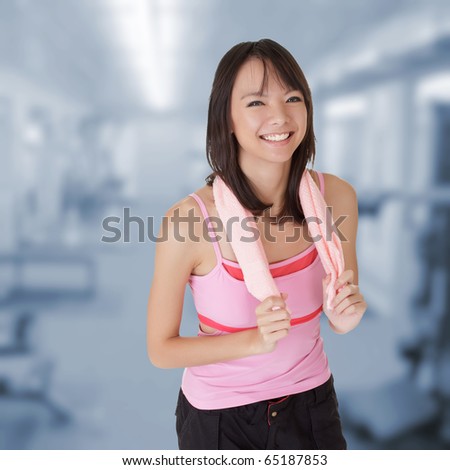 Young girl of fitness smiling in gym.