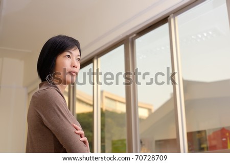 Asian woman with confident expression, closeup portrait indoor.