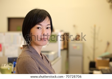 Mature business woman of Asian, closeup portrait in office.