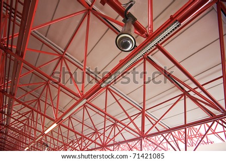 Red metal bracket and the camera on the roof in public spaces