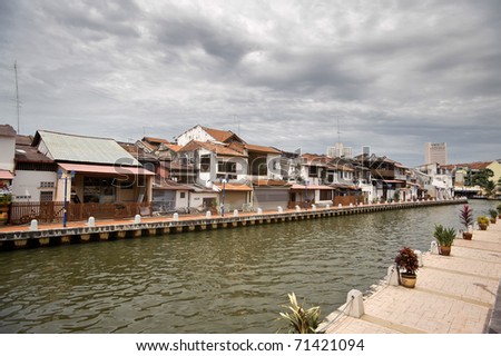 Traditional red brick and white walls of the house and sidewalk of river bank in Malacca, Malaysia, asia