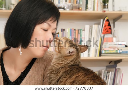 Cat kiss her master, woman with pet in home.