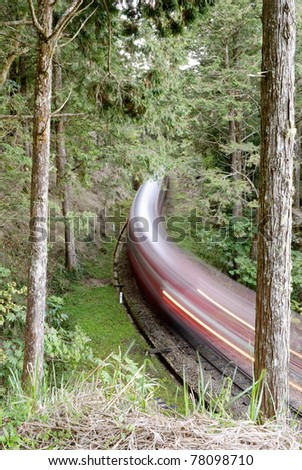 Forest railway with train move blurred in Alishan National Scenic Area, Taiwan, Asia.