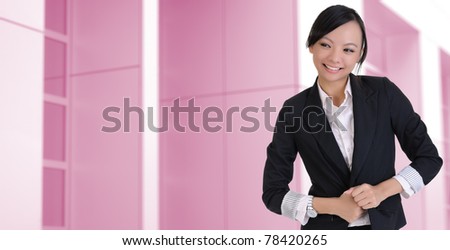 Attractive businesswoman with smiling expression, closeup portrait on business buildings.