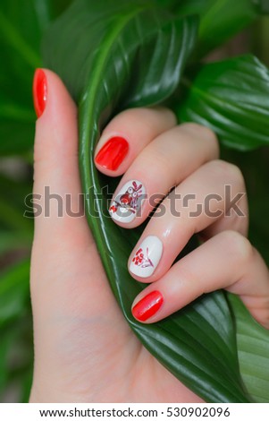 Woman with beautiful manicured blue fingernails gracefully crossing her hands to display them to the viewer, glamour and beauty concept. new year. on mountain ash
