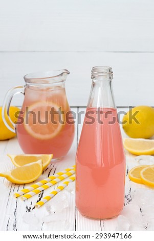 Refreshing homemade pink lemonade on white old vintage wooden background
