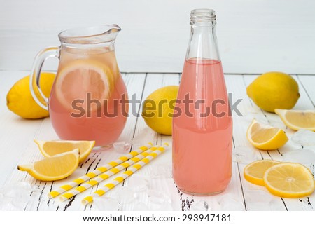 Refreshing homemade pink lemonade on white old vintage wooden background