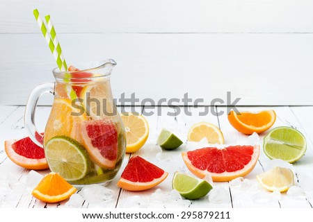 Detox citrus infused flavored water. Refreshing summer homemade cocktail with lemon, lime, orange and grapefruit