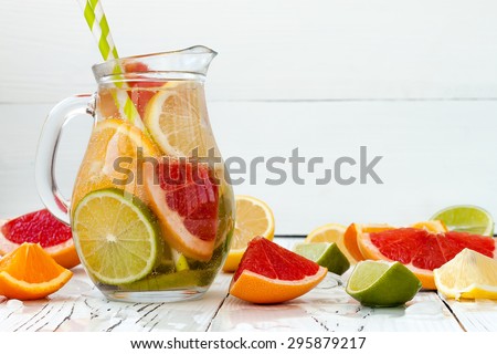 Detox citrus infused flavored water. Refreshing summer homemade cocktail with lemon, lime, orange and grapefruit