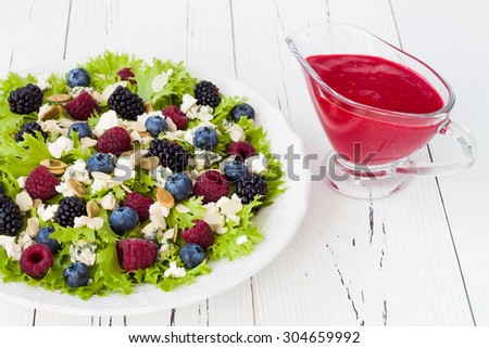Summer refreshing mixed berry salad with pumpkin seeds, blue cheese, feta and sweet red raspberry vinaigrette
