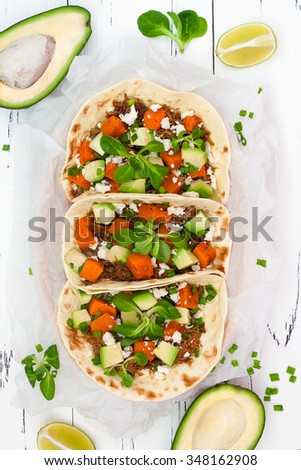 Mexican tacos with meat, sweet potatoes and cotija cheese