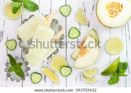 Refreshing mexican style ice pops - cucumber, lime, honeydew margarita paletas - popsicles. Top view,  overhead. Cinco de Mayo recipe