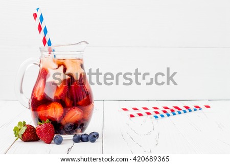 Red, White and Blue Lemonade or Sangria. Patriotic drink cocktail with strawberry, blueberry and apple for 4th of July party