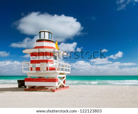 Miami Beach Florida, lifeguard house in a typical colorful Art Deco style on a bright sunny summer day, with blue sky and Atlantic Ocean in the background. World famous travel location.