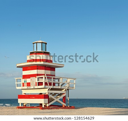 Summer scene with a typical colorful lifeguard house in Miami Beach, Florida with blue sky and ocean in the background