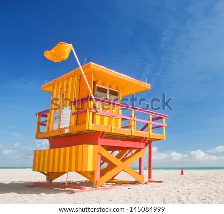 Miami Beach Florida, yellow lifeguard house in typical Art Deco architecture during summer day with blue sky