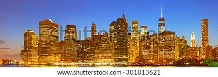 New York City skyline at sunset and lights from financial buildings in Manhattan