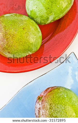 Mango tropical fruit assortment on red and blue plates