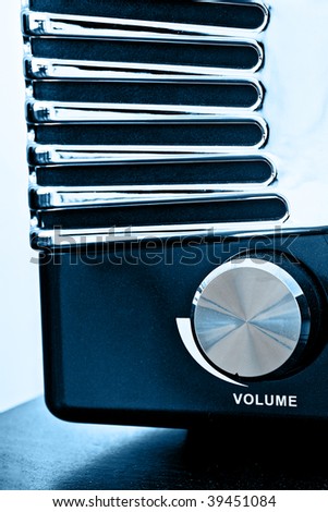 Vintage radio with closeup of the volume button. Color processed