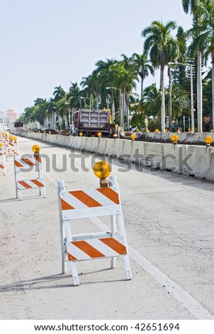 Street signs and barricades at a public construction site
