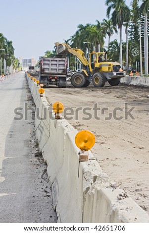 Street signs and barricades at a public construction site