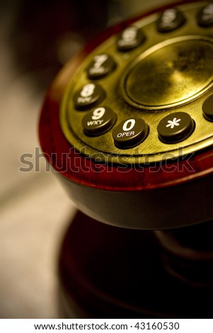 Vintage antique telephone detail in low light with selective focus, dial zero for operator