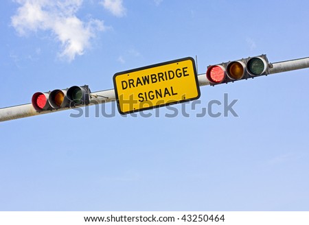 Drawbridge sign with red traffic light on