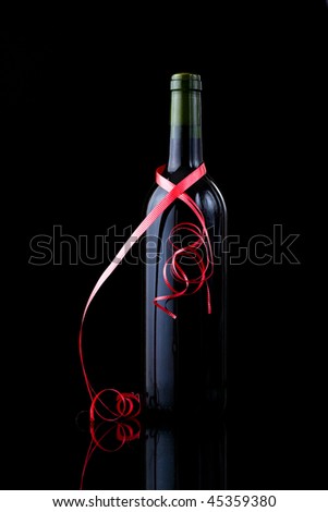 stock photo : Bottle of red wine wrapped in a red ribbon, Valentines day 