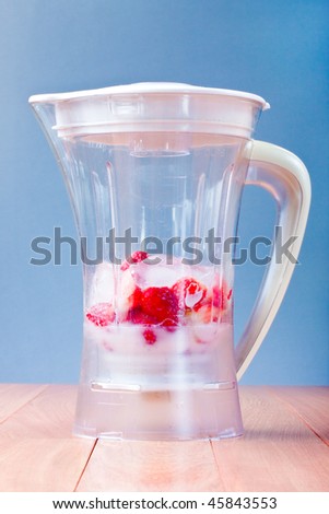 Fresh Strawberries and ice in a blender, for fruit milkshake