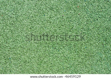 Background texture of green  crumb rubber used for athletic tracks and children playgrounds