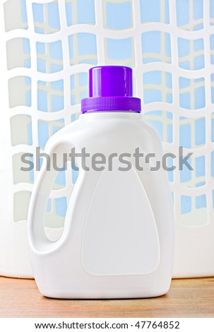 Plastic detergent container with a purple cap and a laundry basket. White blank tag