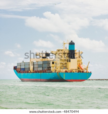 Cargo ship loaded with containers is leaving the port