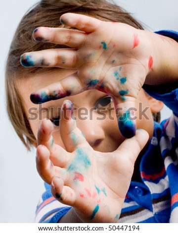 Three year old child with painted fingers