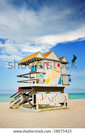 Summer scene with a typical colorful lifeguard house in Miami Beach, Florida with blue sky and ocean in the background