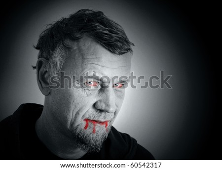 Evil and scary vampire with a blood dripping from his mouth and bloody eyes, halloween photo montage