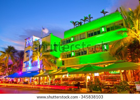 Miami Beach, Florida Moving traffic hotels and restaurants at sunset on Ocean Drive, world famous destination for it\'s nightlife, beautiful summer  weather and pristine beaches