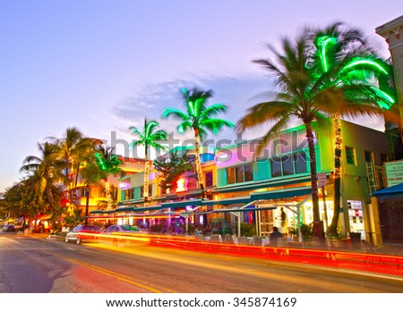 Miami Beach, Florida USA-November 10, 2015: Moving traffic, Illuminated hotels and restaurants at sunset on Ocean Drive, world famous destination for nightlife, beautiful weather, Art Deco and beaches