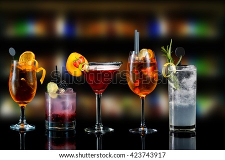 Selection of cocktails martini spritz bramble gin tonic bar blurred background